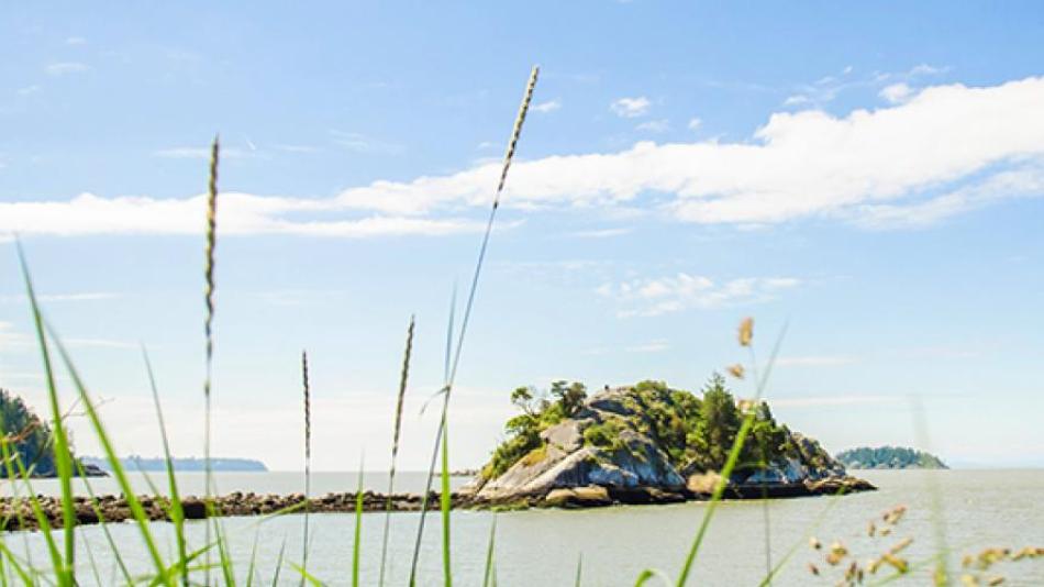 A small rocky peninsula in a small bay.  